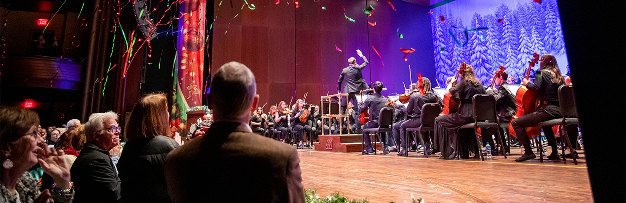 Holiday confetti falls from the ceiling during the Holiday Happening concert