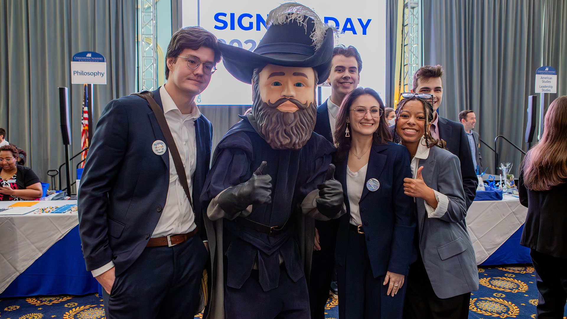 A group of students gather around Captain Chris, CNU's mascot