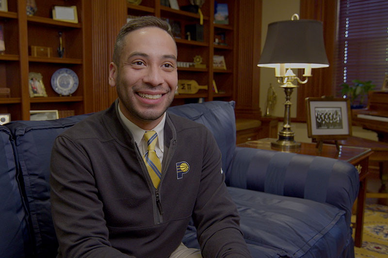 Rico Francis '18 sitting on a couch for an interview