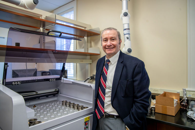 Dr. Tarek Abdel-Fattah stands in a chemistry lab.