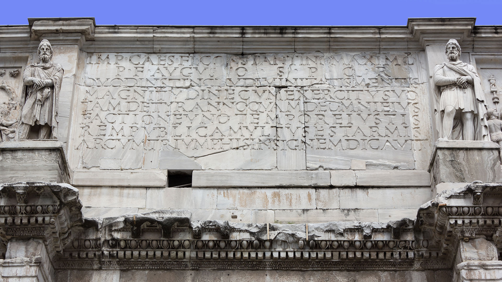 Latin writing carved into an old Roman building