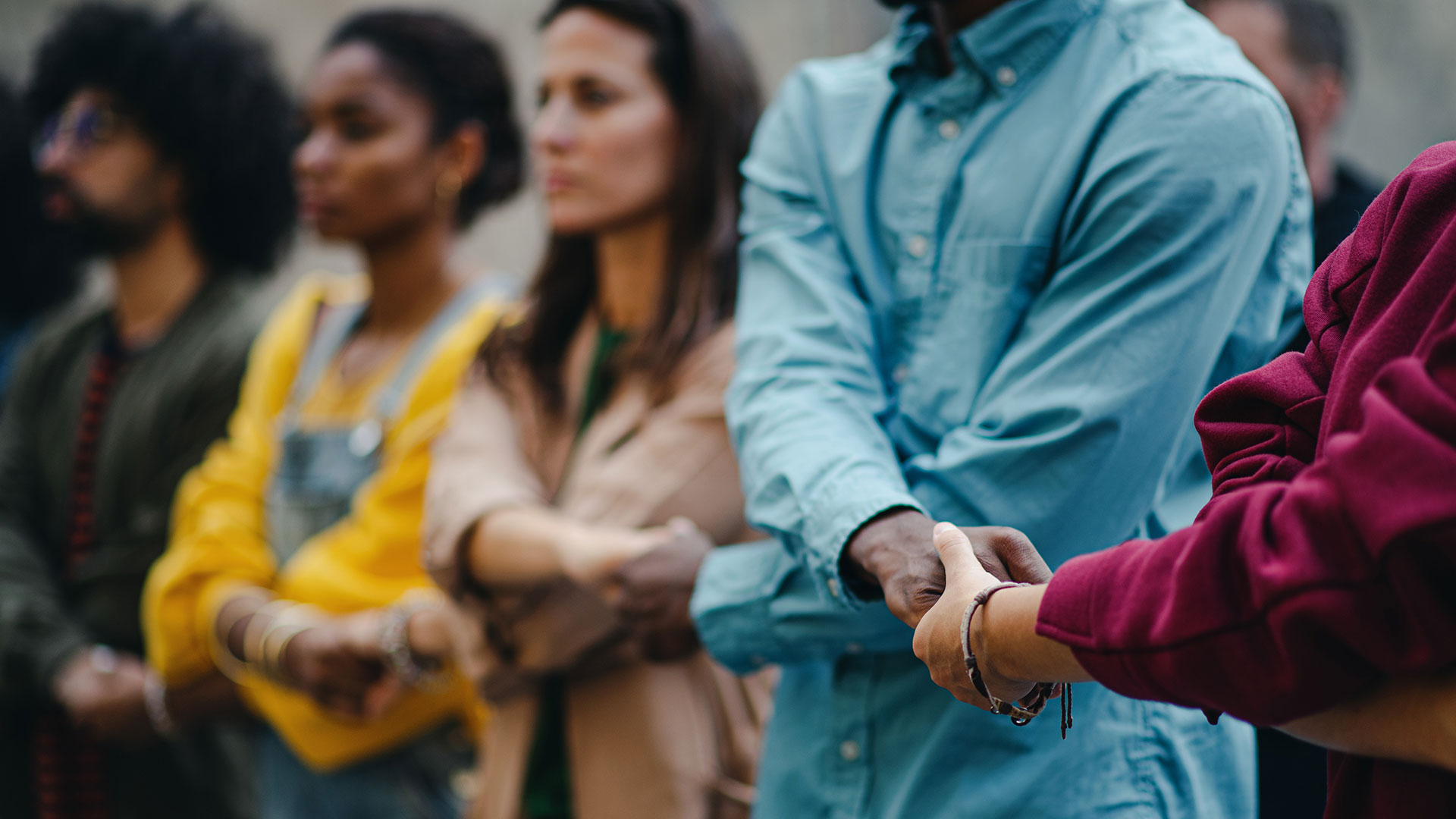 People holding hands and forming a chain