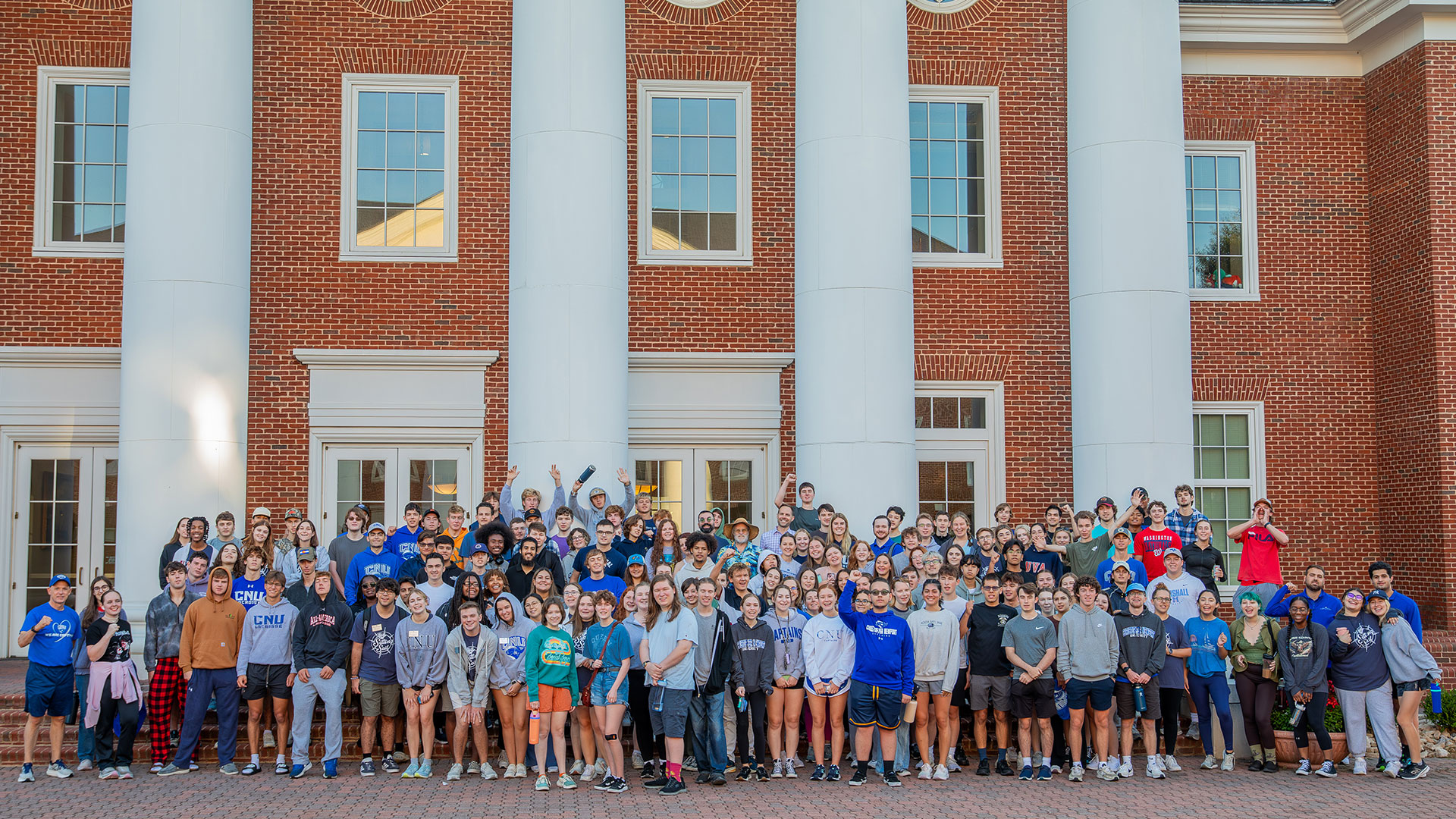 A group of freshman students on the steps of the Trible Library.