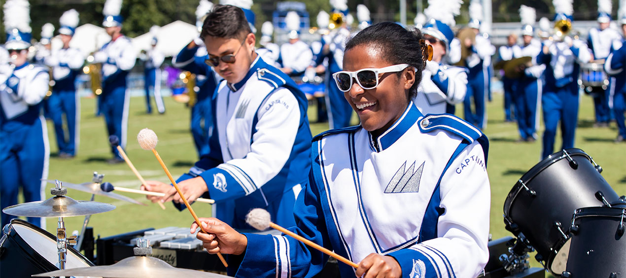 Marching Captains playing drums during a football game
