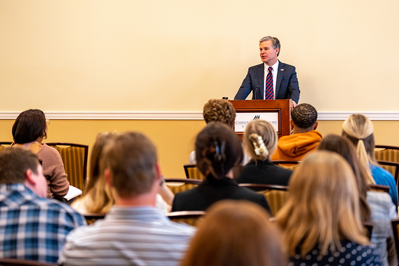 FBI Director Christopher Wray stands at a podium to talk with CNU students.