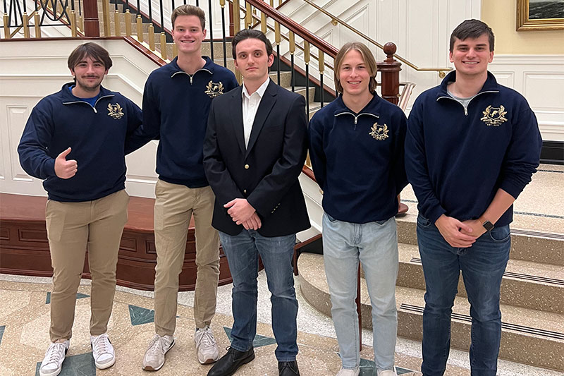 Members of the Captains' Educational Enrichment Fund team pose in the Luter School of Business lobby.
