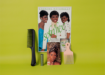 Nakeya Brown sofn'free poster with a comb and hair pick