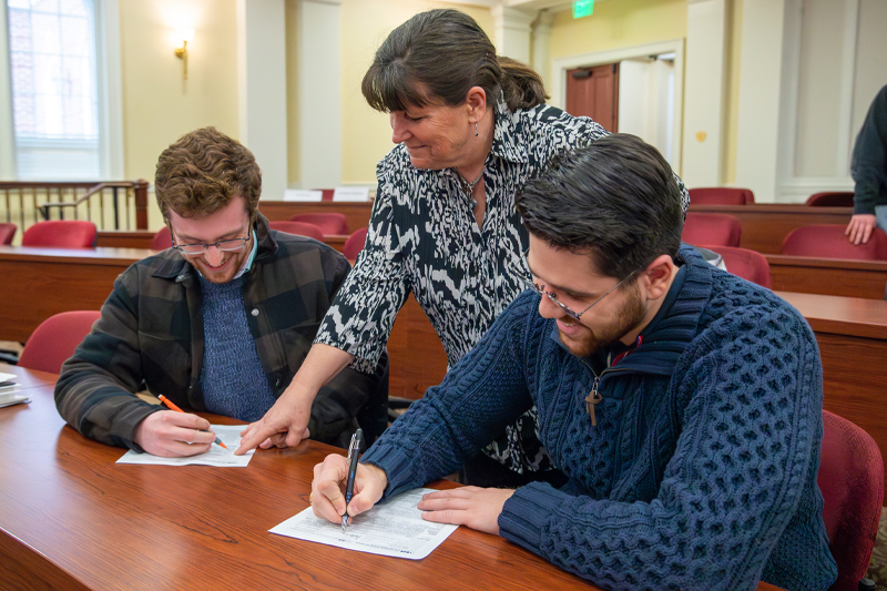 Professor guides students in filling out tax paperwork