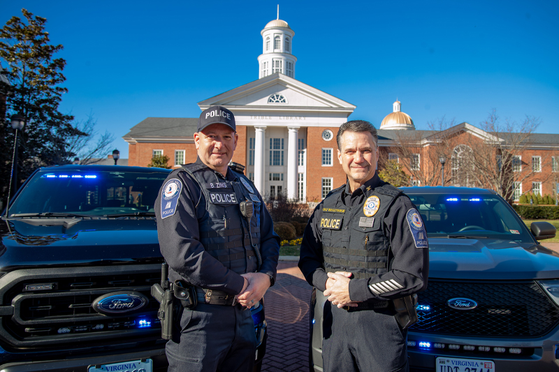 Two police officers showing their new uniforms
