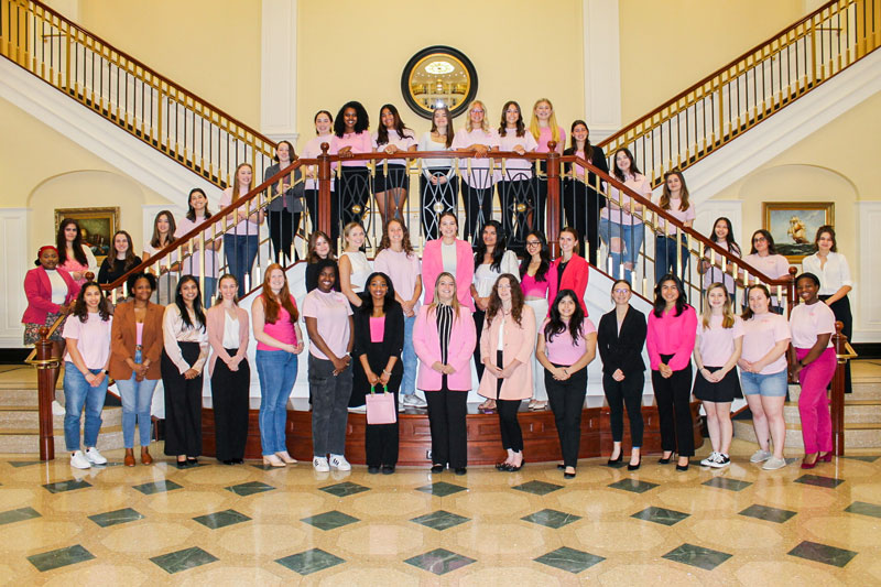 Members of CNU's Women in Business Club pose on the main stairs of Luter Hall.