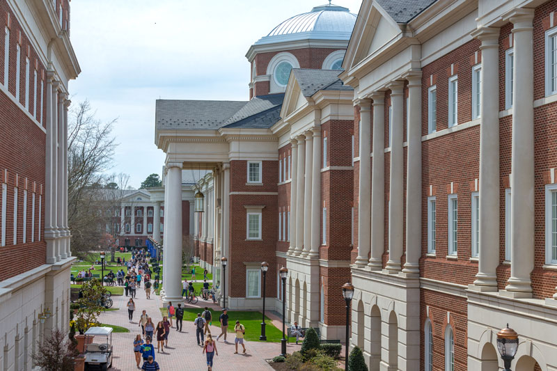 A side exterior shot of Luter Hall while students walk to class on campus.