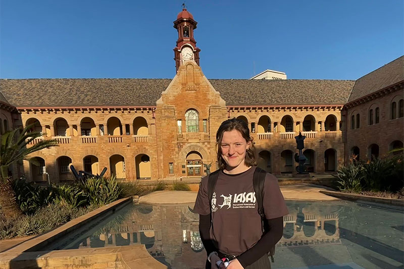 Chloe Grell stands in front of a building in South Africa.