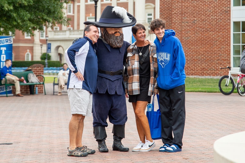 A family poses with Captain Chris