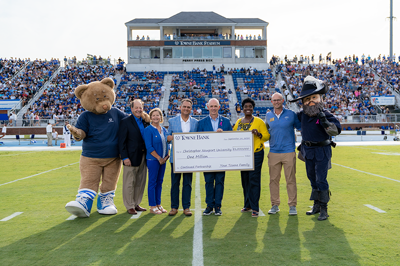 Members of TowneBank and Christopher Newport pose for a photo with a one million dollar check at TowneBank Stadium