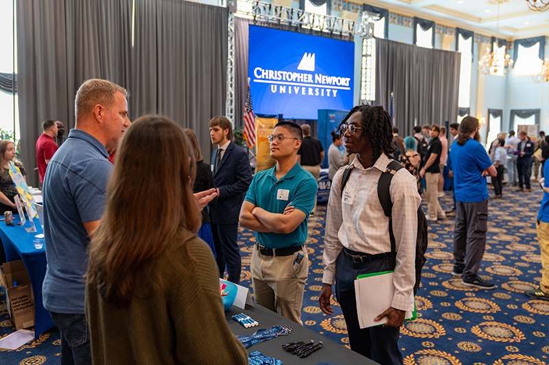 Students talking with potential employers at a job fair.