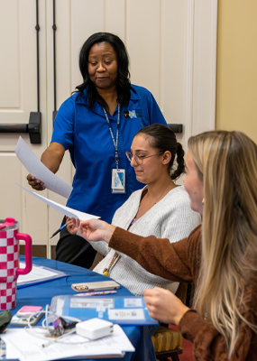 A staff member from NNPS offers a contract to a student.