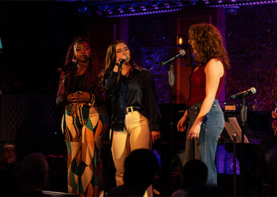 Kylee, center, sings on stage at 54 Below in New York City.