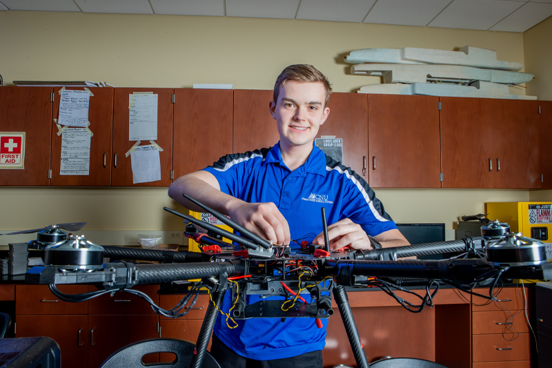 student working on a drone