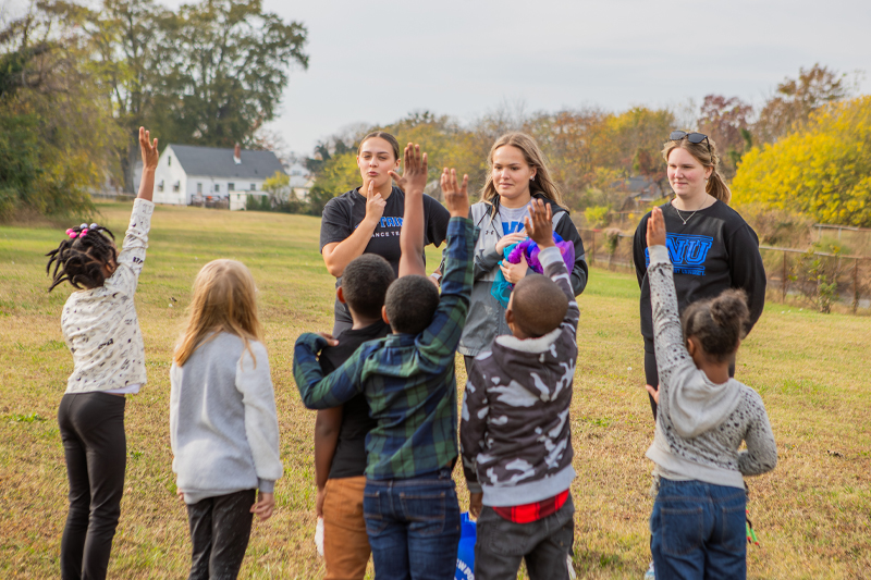 children raising their hands