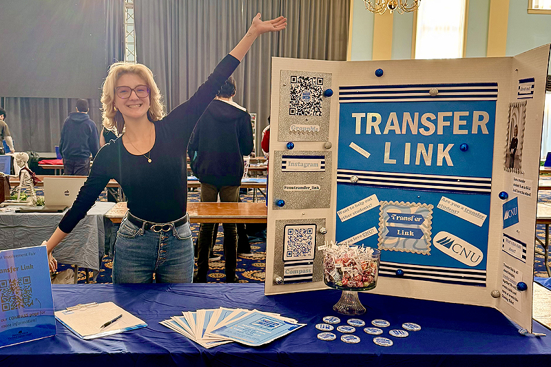 Elliot Bruce poses with a posterboard advertising her Transfer Student Club, Transfer Link