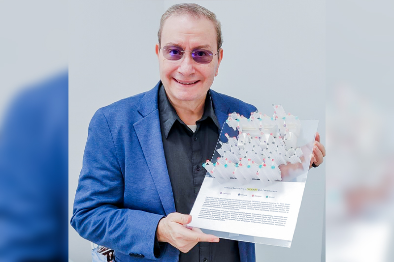 Chemistry professor Dr. Tarek Abdel-Fattah holding new compound
