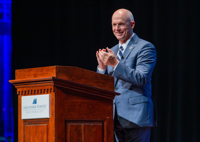 Christopher Newport President William Kelly at a podium delivering the State of the University address.