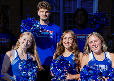 CNU basketball player Luka Matic with members of the cheerleading squad.