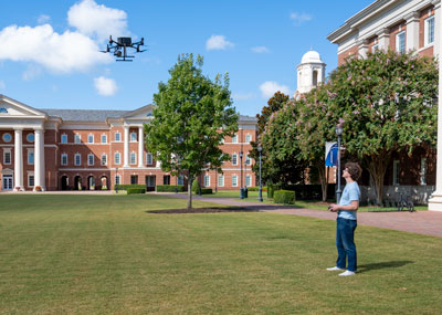 Summer Scholar William Murray flies a drone equipped with a thermal camera that he uses to detect deer in Mariners' Park