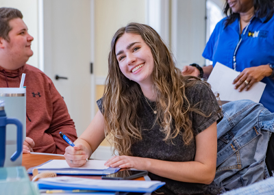 Student smiling while signing her job offer