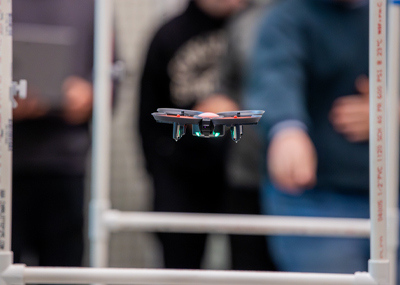 Drone being flown in SERC drone lab obstacle course