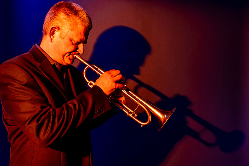 Dr. Kelly Rossum playing a trumpet