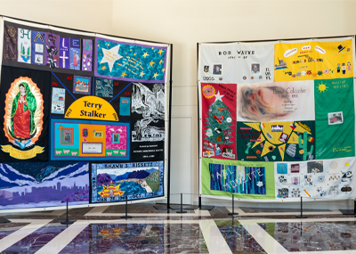 Two quilts hanging side by side.