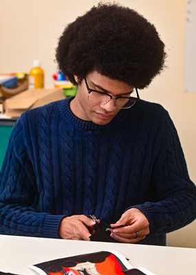A student works on a quilt patch