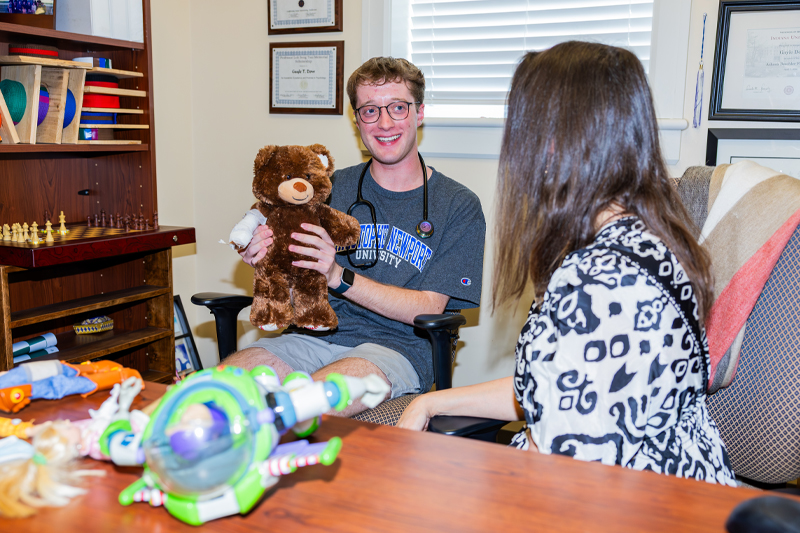 Student and professor with bear