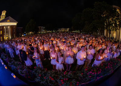 CNU seniors wear white and hold a candle as part of the Candlelight Ceremony