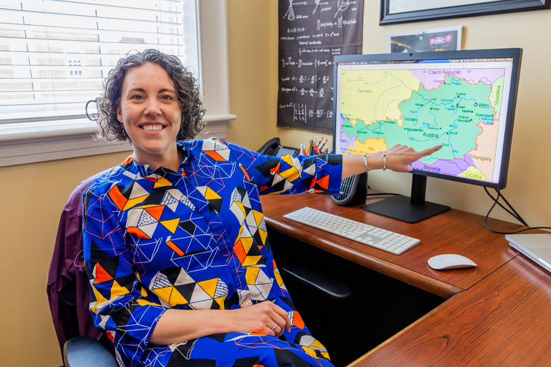 Dr. Jessica Stewart Kelly pointing to a map of Austria on a computer