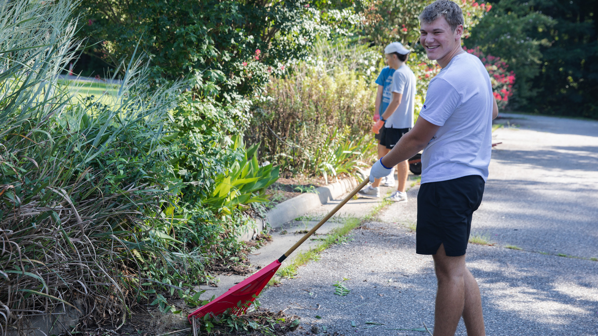 A student rakes outdoors