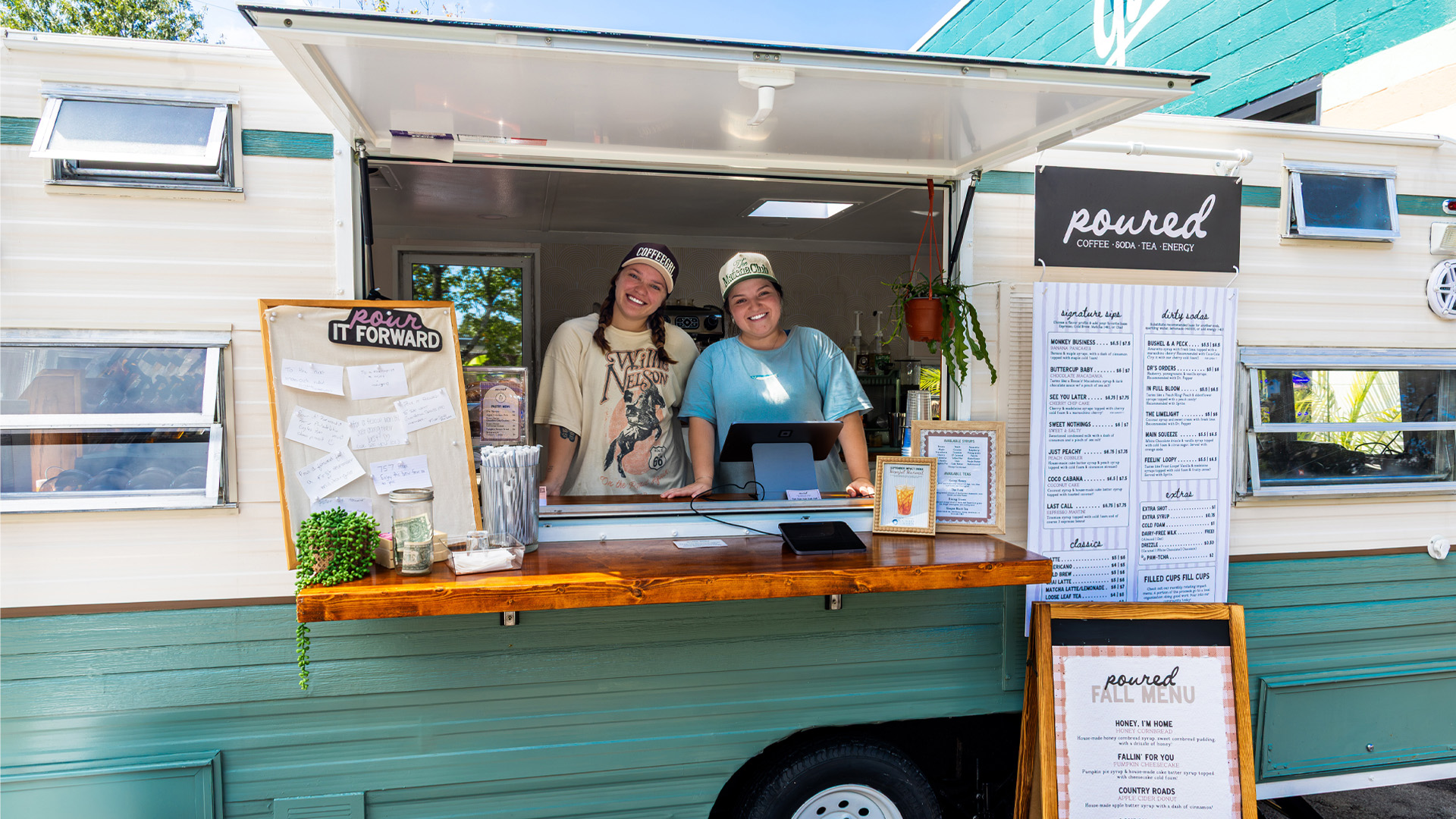 Two CNU alumna pose in their mobile coffee shop