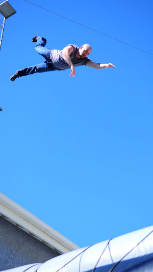 CNU alum Greg Poljacik falls onto an air bag