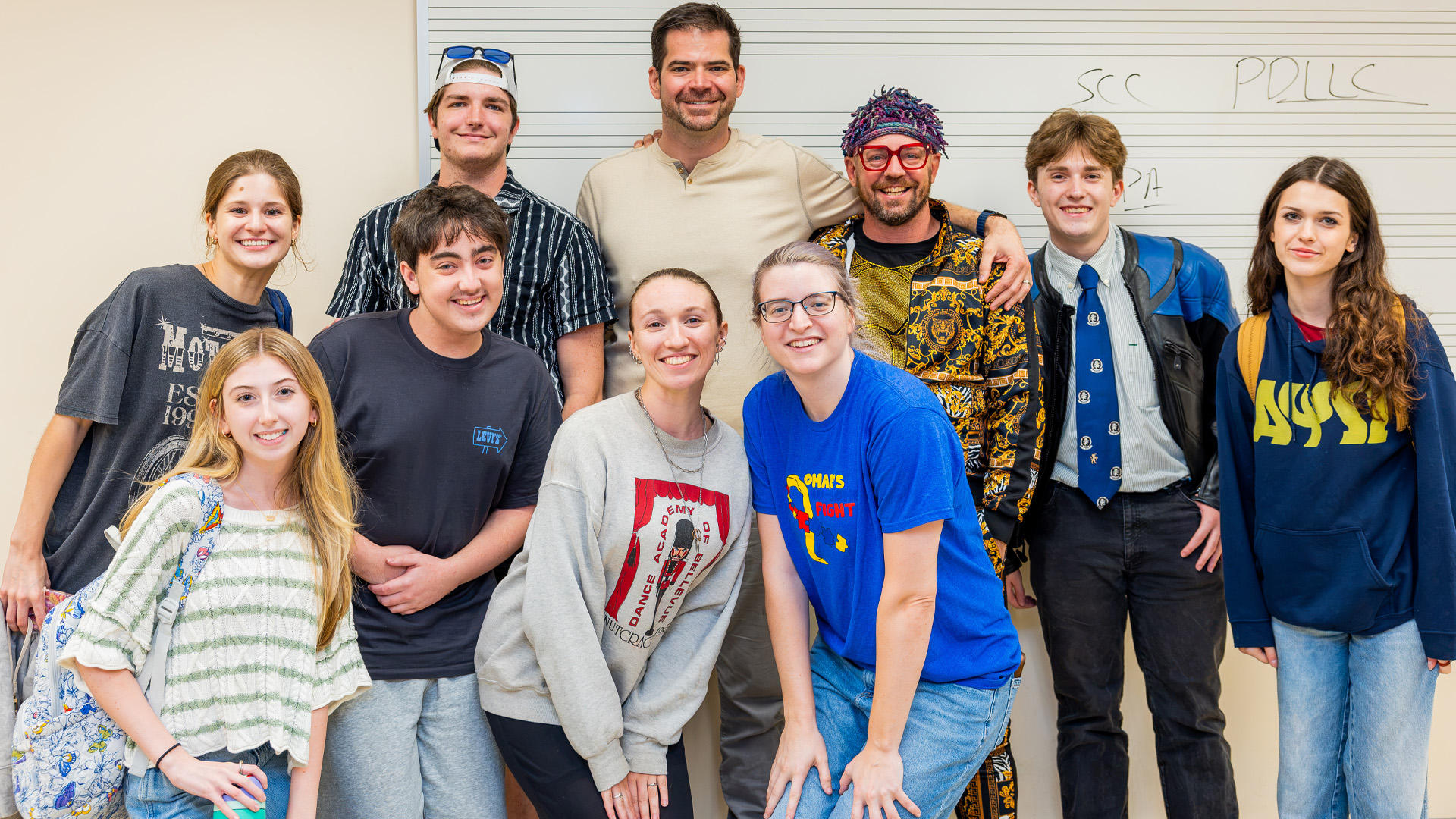 Greg Poljacik back center stands with a group of CNU theatre students.