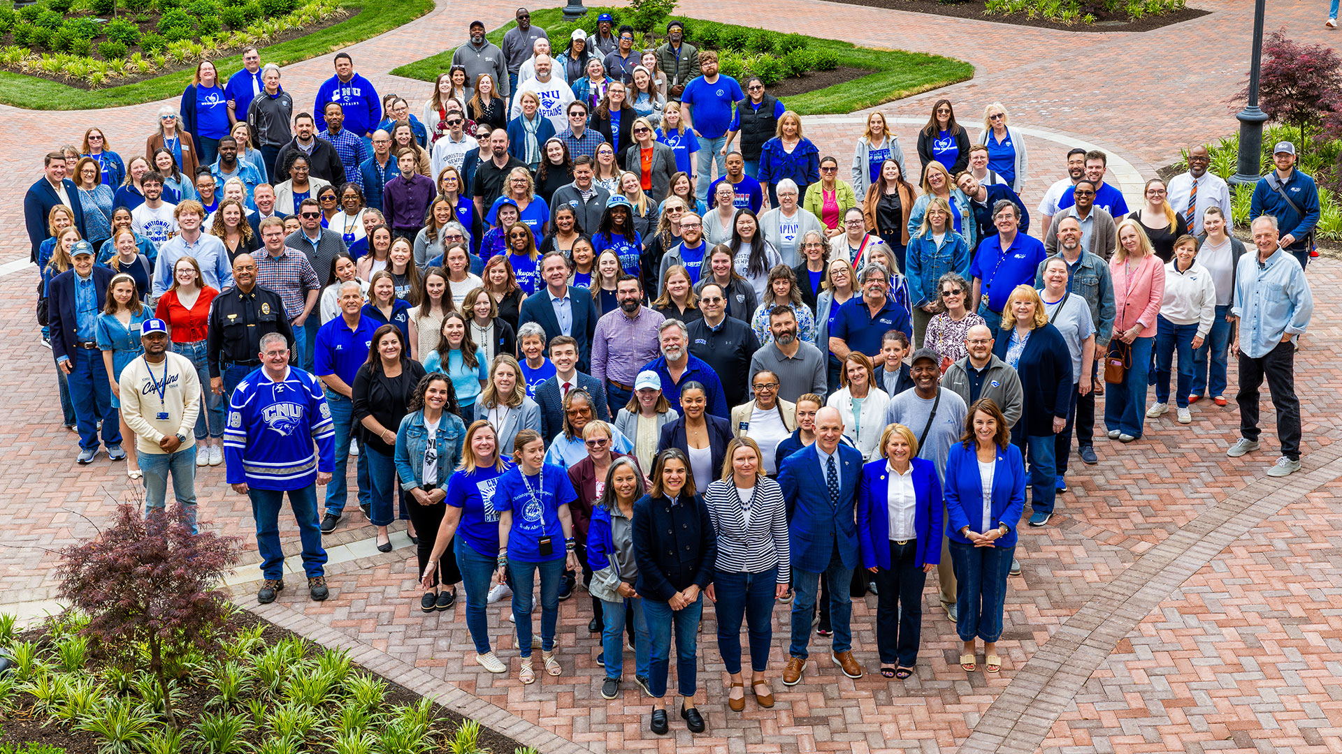 Staff and faculty gathered in the Science and Engineering Research Center courtyard wearing denim