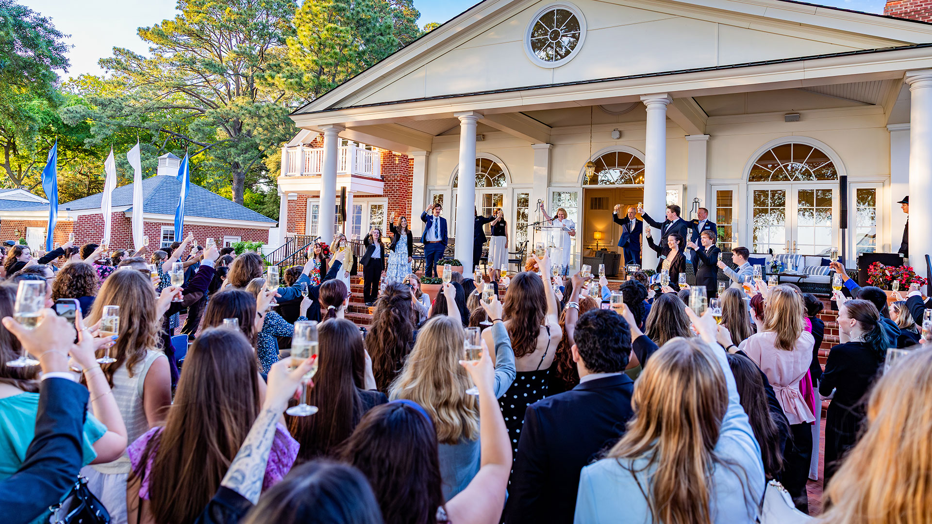 Members of the Class of 2026 raise their glasses in a toast