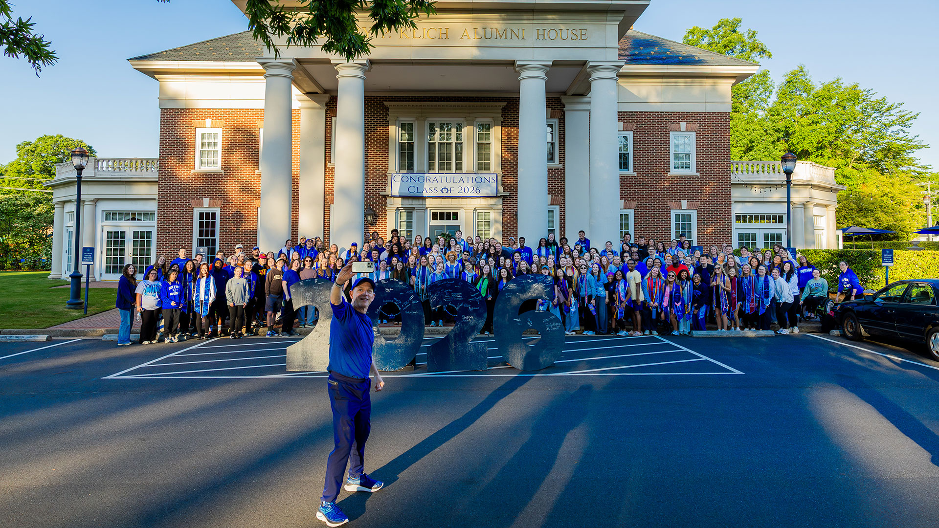 CNU President Bill Kelly takes a selfie with members of the class of 2026